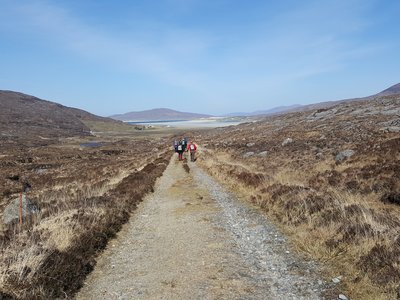 Centre view of road leading to walking group in distance, Outer Hebrides, Scotland