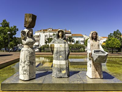  A set of three statues positioned in a water feature located in the Praça Al'Mutamid within the city of Silves, Algarve, Portugal