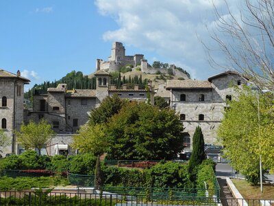 Rocca Maggiore fortress on hill in background overlooking citadel of Asissi, Italy