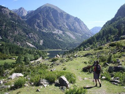 Woman walking towards lake in Aiguestortes National Park, Catalonia, Spain, Europe