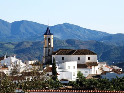 Incarnation church from 1505 and whitewashed town houses surrounding in Yunquera village, Andalucia, Spain
