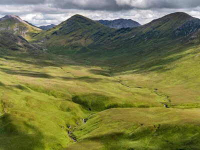 Green valley in Connemara National Park with the Twelve Bens Mountains in the background, Ireland