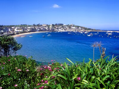 St Mary's Hugh Town with beach and boats floating nearby, Isles of Scilly, England