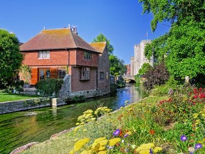 Westgate Gardens with flowers and medieval tower in historic Canterbury, Kent, England