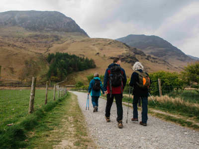 Small walking group walking on path near Buttermere Lake, Lake District