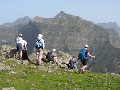 Group of hikers resting to take in view of mountains near Fontes, near Ponto do Sol, Madeira, Portugal
