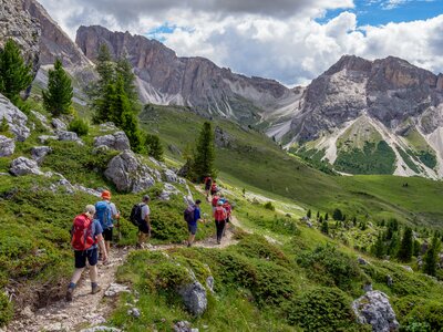 Walkers approaching the Dolomites, Italy on a narrow path